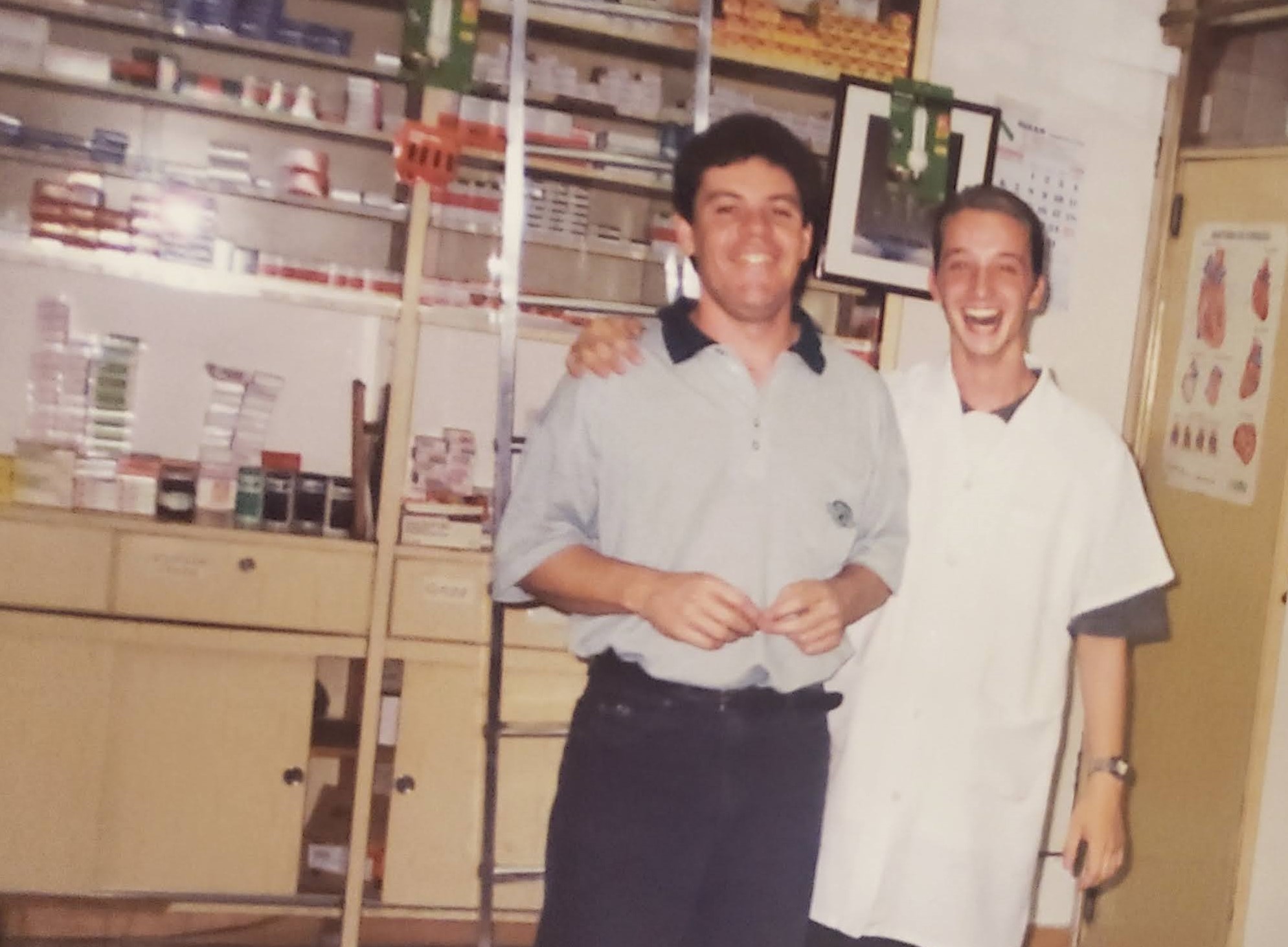 Old photo of two young men smiling