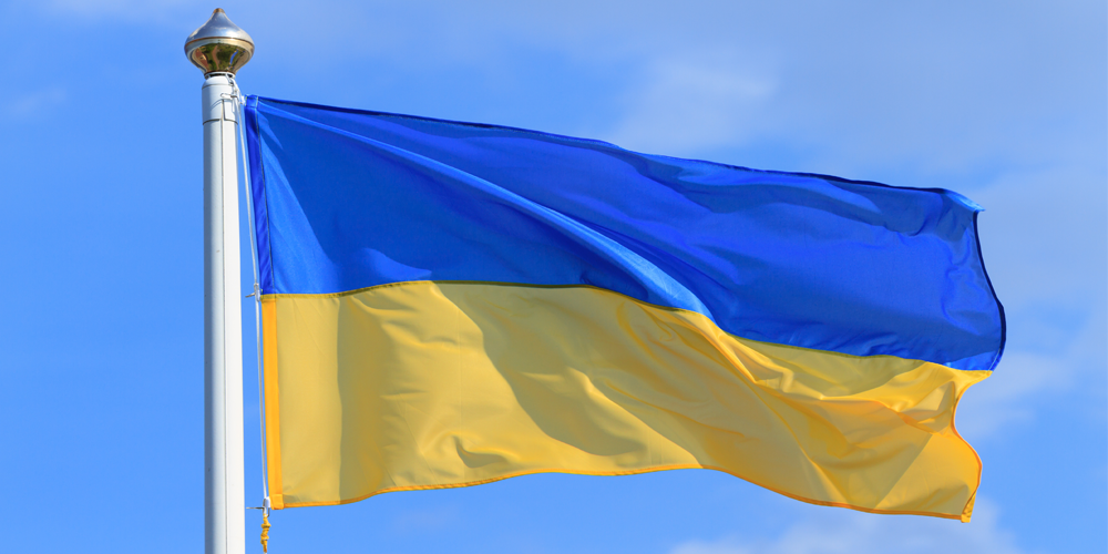 Yellow and blue Ukraine flag on blue sky background