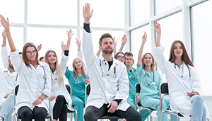 Group of health care practitioners, multi ages, sexes and ethnicities in class room setting