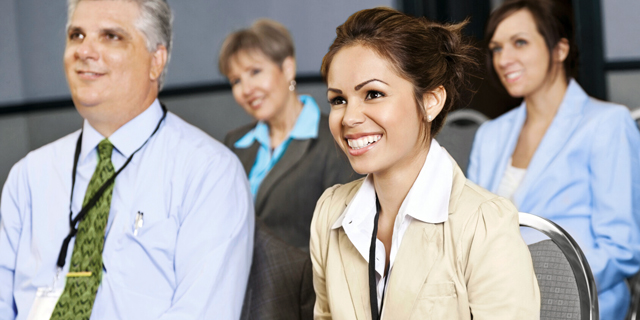 Male and female, of differing ethnicities, wearing business suits, having discussion