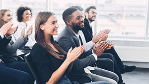 Group of business people, multi ages, sexes and ethnicities in class room setting