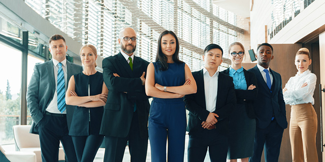 Group of business people, multi ages, sexes  and ethnicities in class room setting