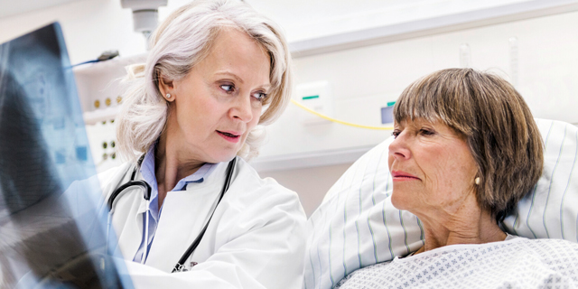 Caucasian female health care practitioner caring for Caucasian female patient