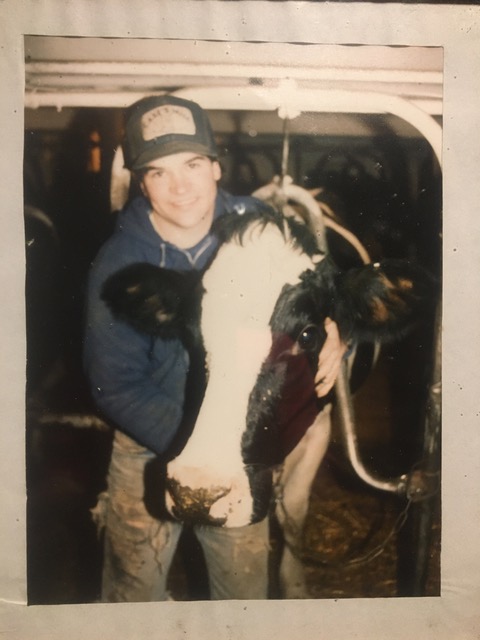A young Dale caring for a cow on his family’s dairy farm in St. Johnsville, New York.