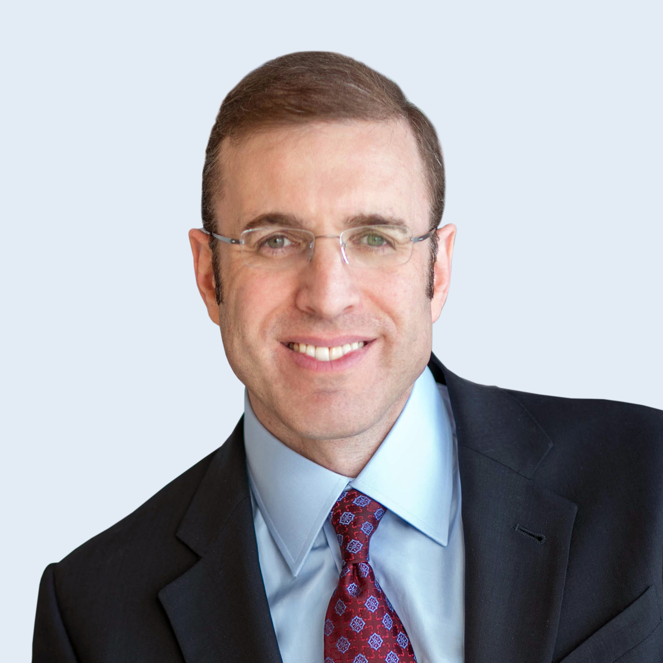 A headshot of Mark Rustein in suit