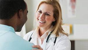 Man and woman of different ethnicities talking and smiling at each other