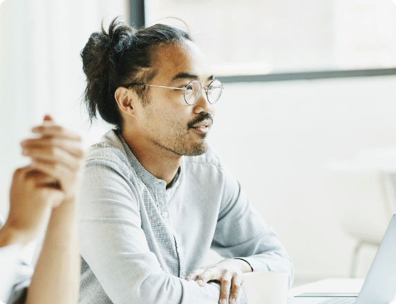 Office employee sitting listening to conversation