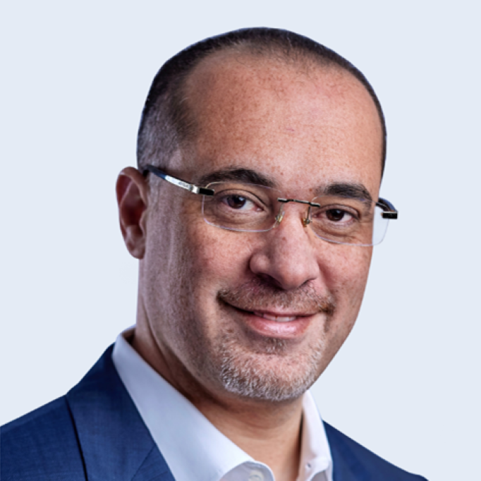 A headshot of Ahmed Kotb in suit