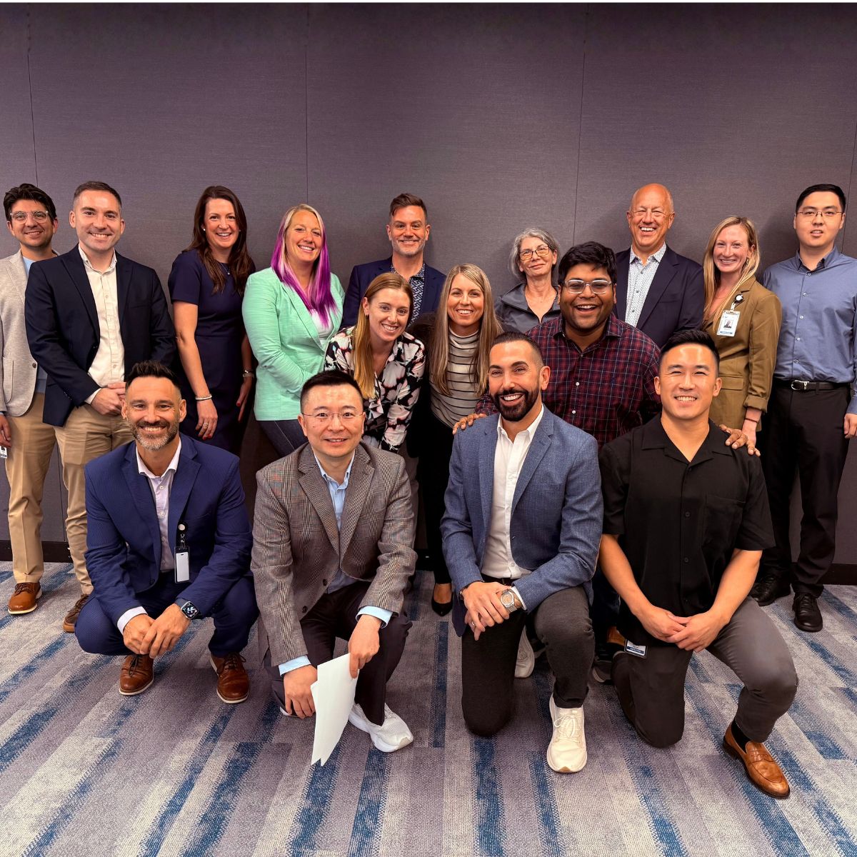 John alongside his team and colleagues. 