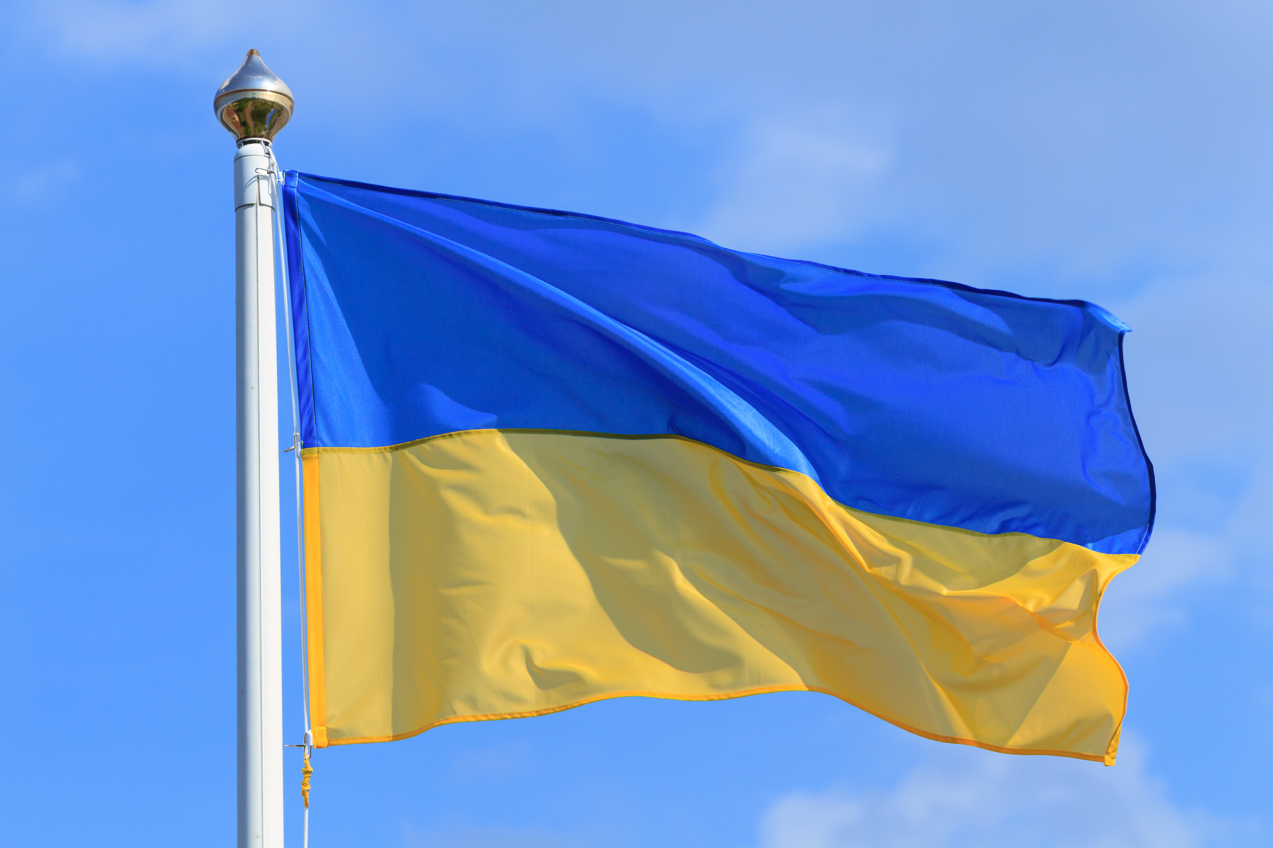 Yellow and blue Ukraine flag on blue sky background